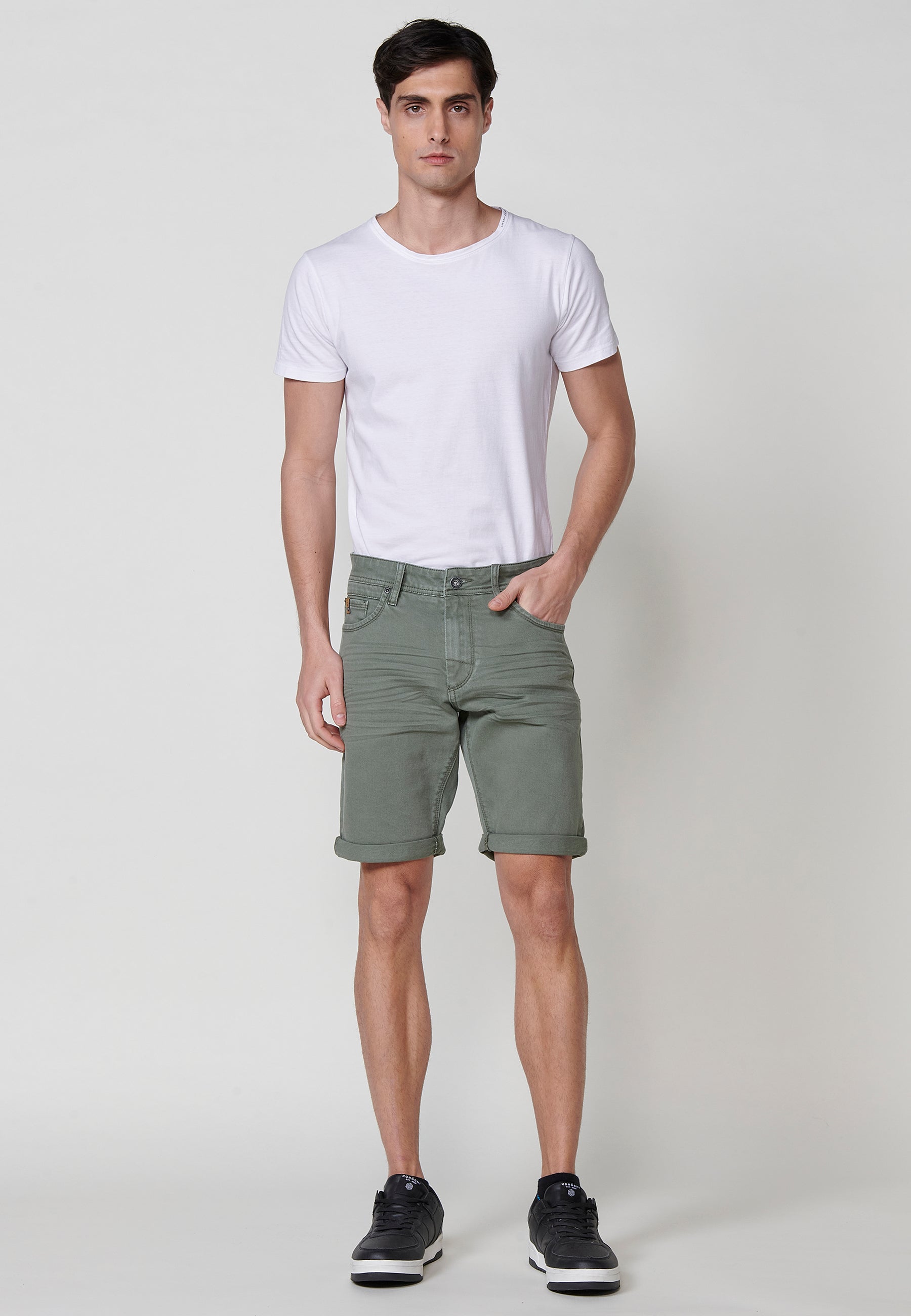 Regular fit Bermuda shorts with front zip and button closure, five pockets, one ticket pocket, and unfastened turn-up hems for men by .