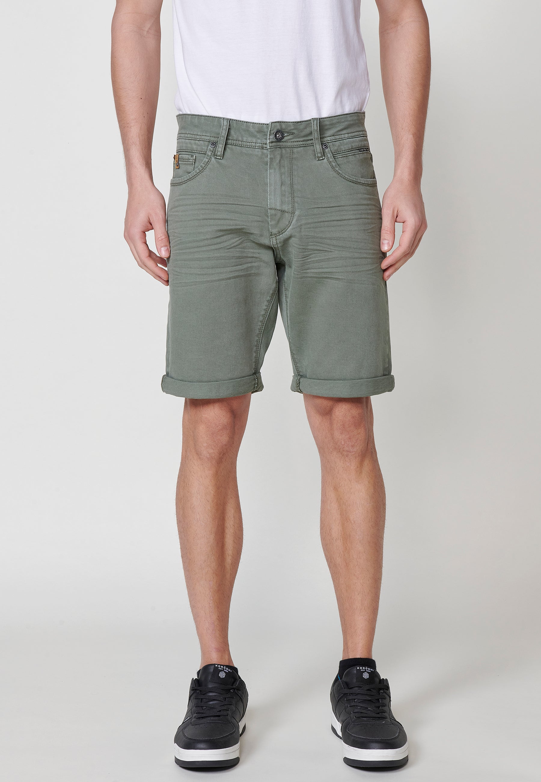 Regular fit Bermuda shorts with front zip and button closure, five pockets, one ticket pocket, and unfastened turn-up hems for men by .