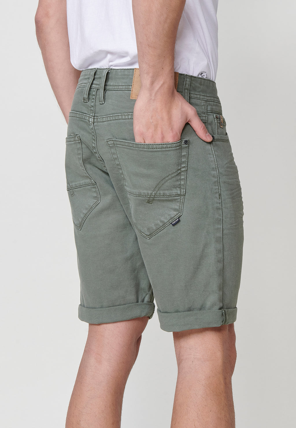 Regular fit Bermuda shorts with front zip and button closure, five pockets, one ticket pocket, and unfastened turn-up hems for men by .