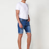 Relaxed-fit denim shorts with front zipper and button closure, five worn-effect pockets, and unfastened turn-up hems for men's medium