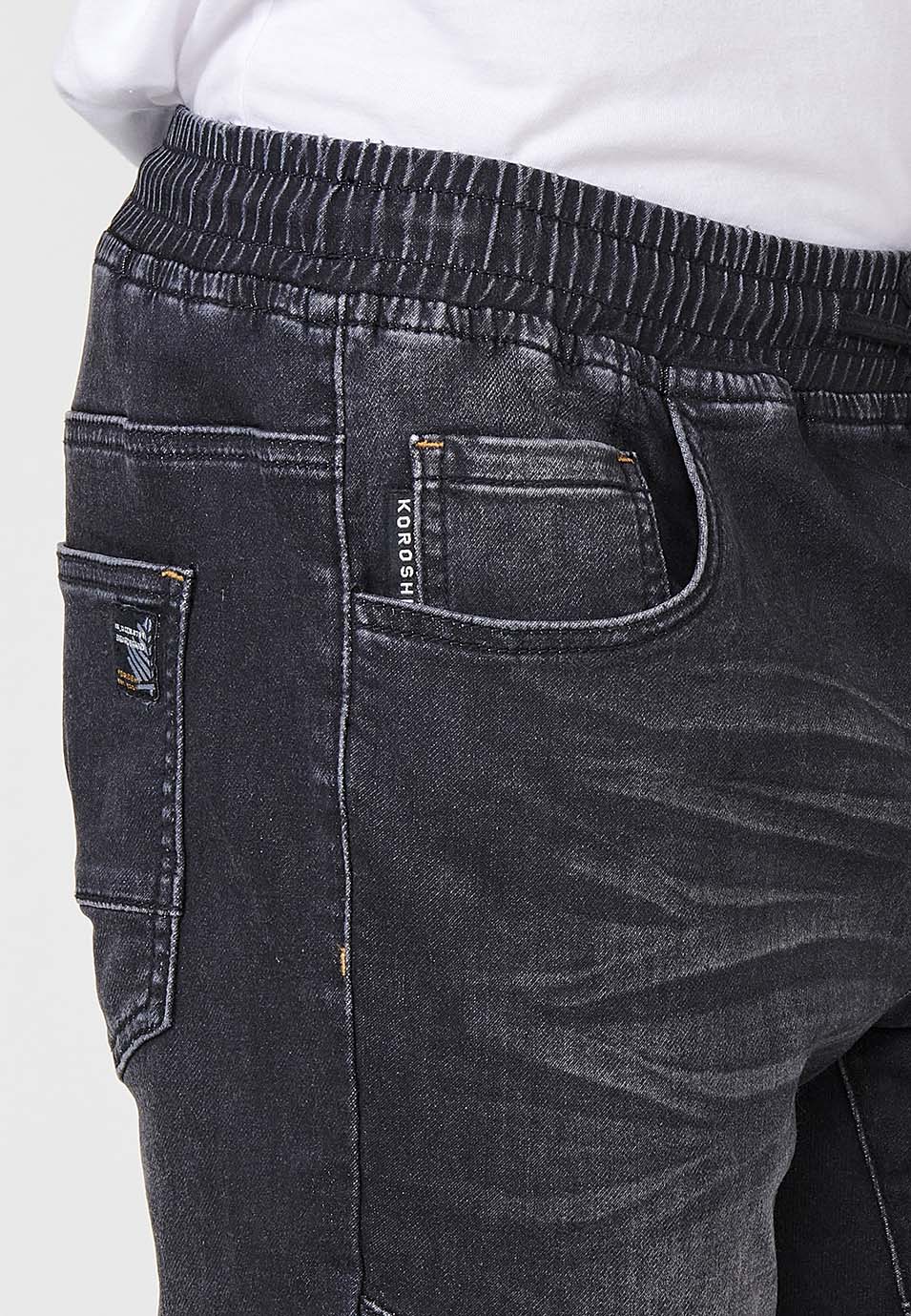 Pantalon de jogging en jean avec taille élastique et cinq poches dont une poche et détails aux genoux pour homme