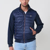 Veste matelassée bleu marine pour homme avec col montant, poches et fermeture éclair sur le devant. Fabriqué en 100% polyester, chaud, léger et polyvalent.