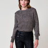 Jersey punto jaspeado mujer, hilo metalizado y brillos decorativos en escote.