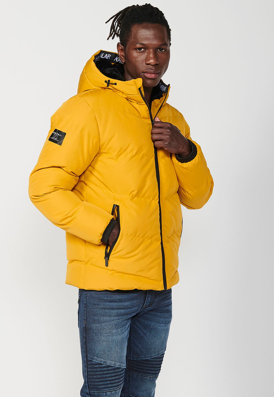 Veste matelassée avec fermeture zippée sur le devant et col à capuche pour homme en jaune 1