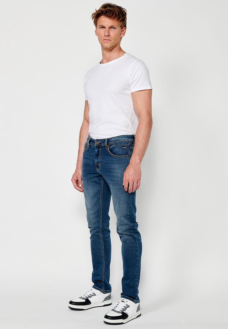 Pantalon long coupe slim avec fermeture éclair sur le devant et fermeture boutonnée en Bleu pour Homme