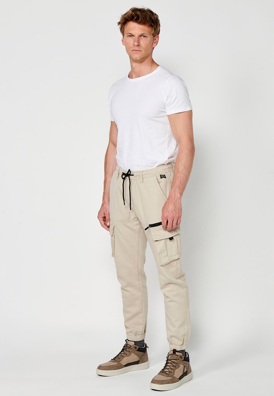 Men's beige jogger long pants with elastic waist and ankles and pockets