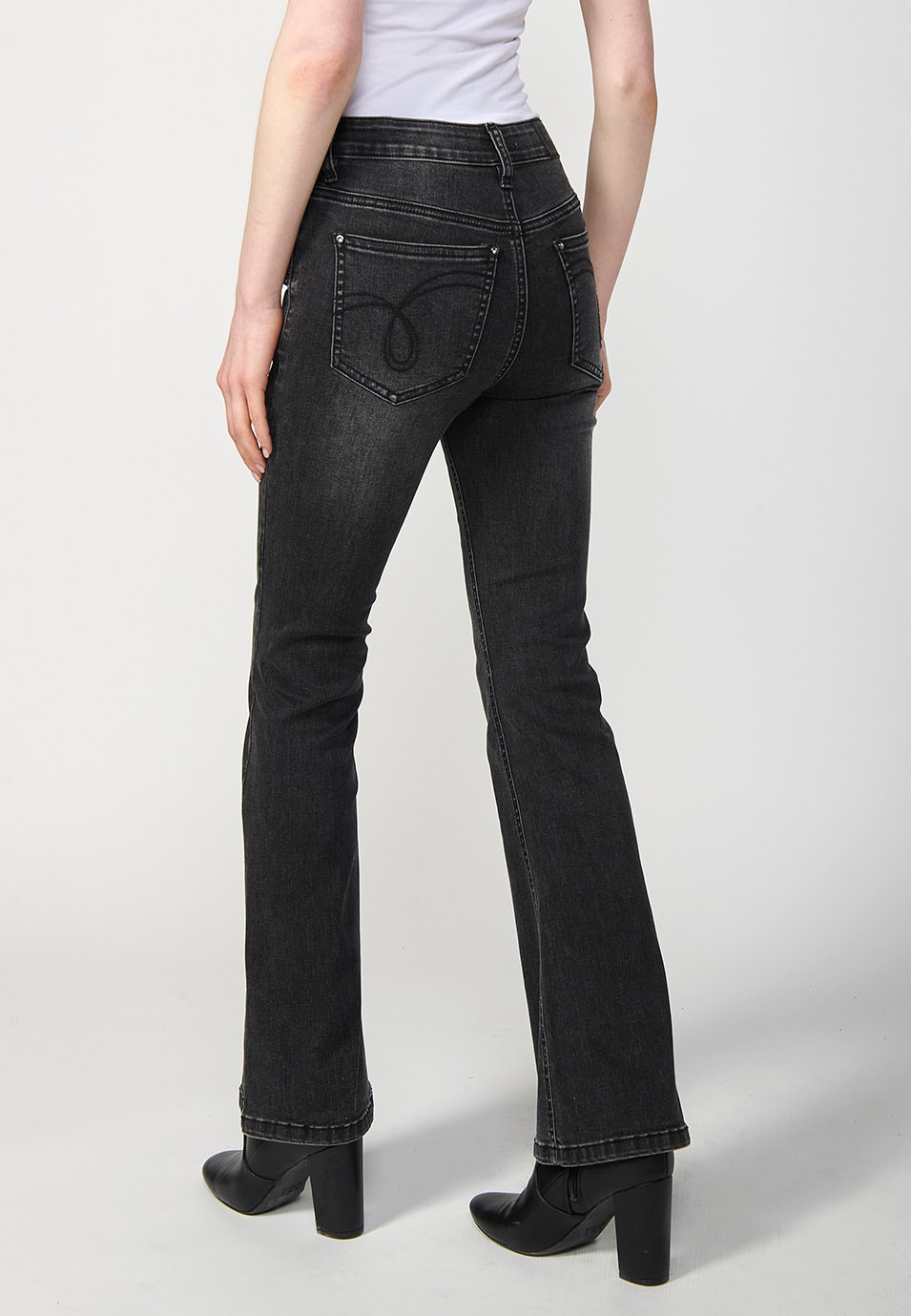 Pantalon en denim boot cut à cinq poches, évasé, couleur noire, avec applications métalliques sur les poches pour Femme