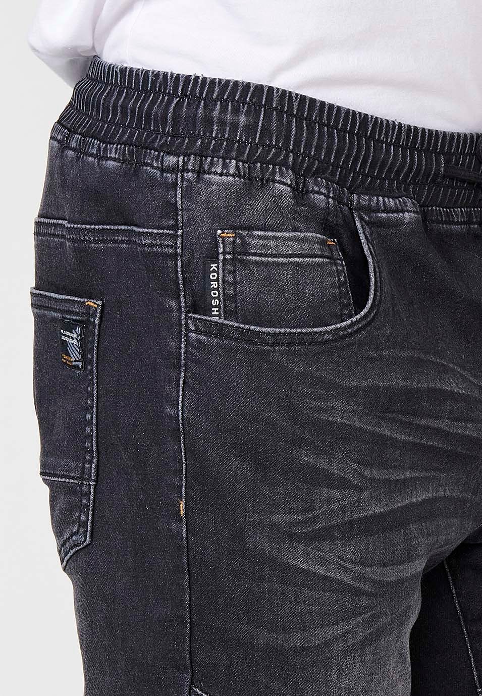 Pantalón jogger denim con Cintura con goma elástica y Cinco bolsillos con uno cerillero con Detalles en las rodillas color Negro para Hombre