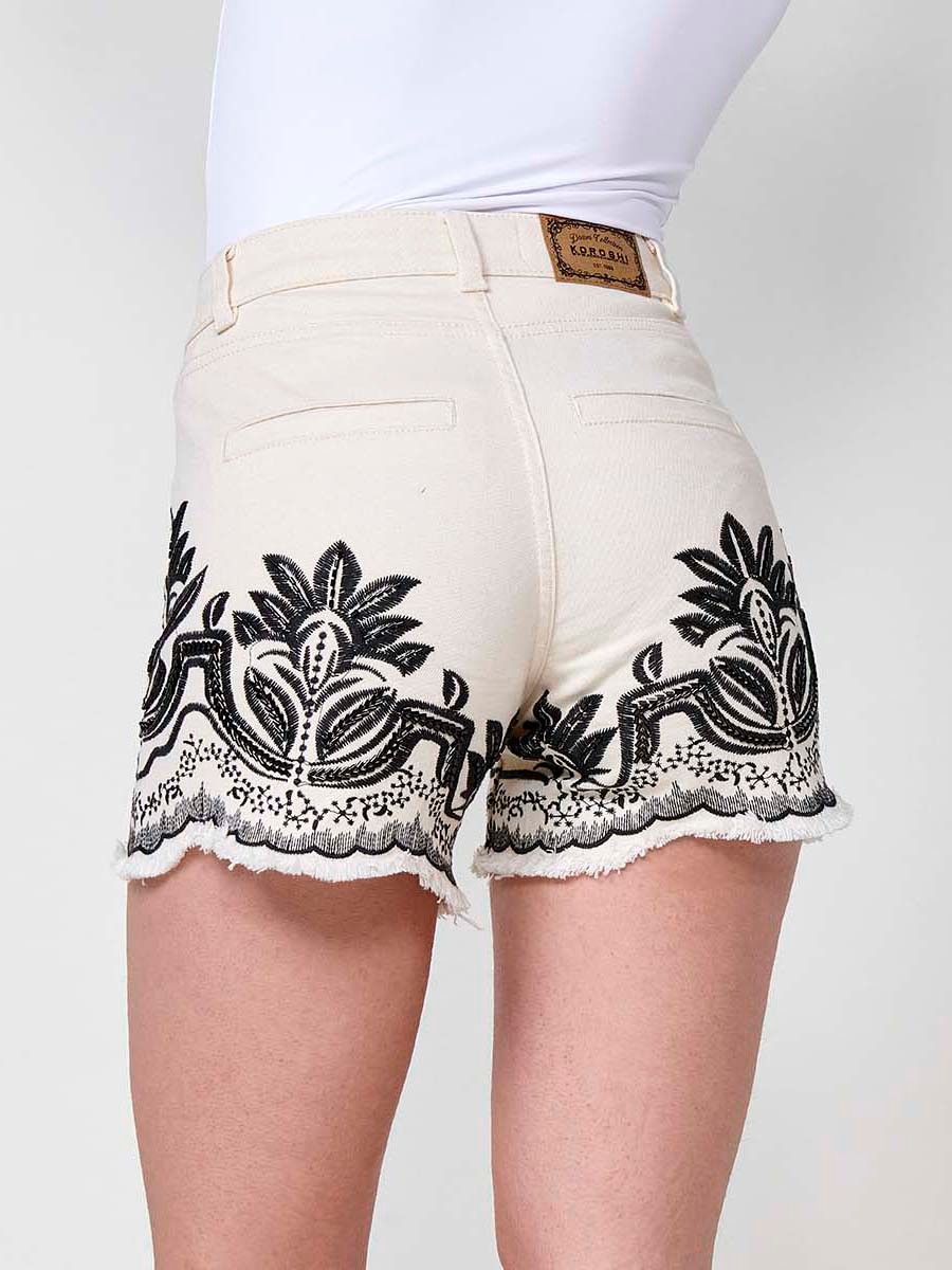 Jeans color short elástico con Tiro medio y cinco bolsillos con Cierre con cremallera y botón metálico con Bordado con motivos florales en cintura y bajo con brillos color Crudo para Mujer 8