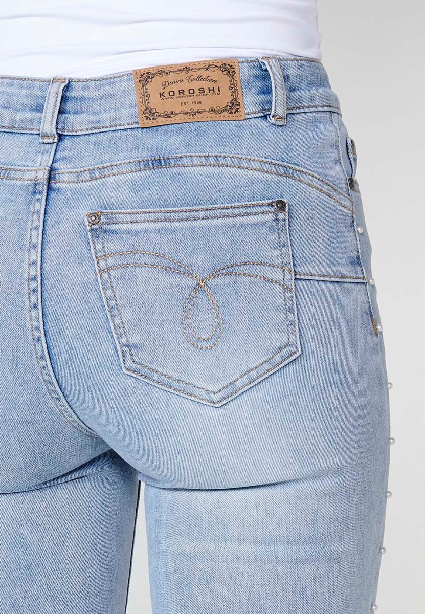 Slim fit jeans with pearl details on the sides in blue for women 1